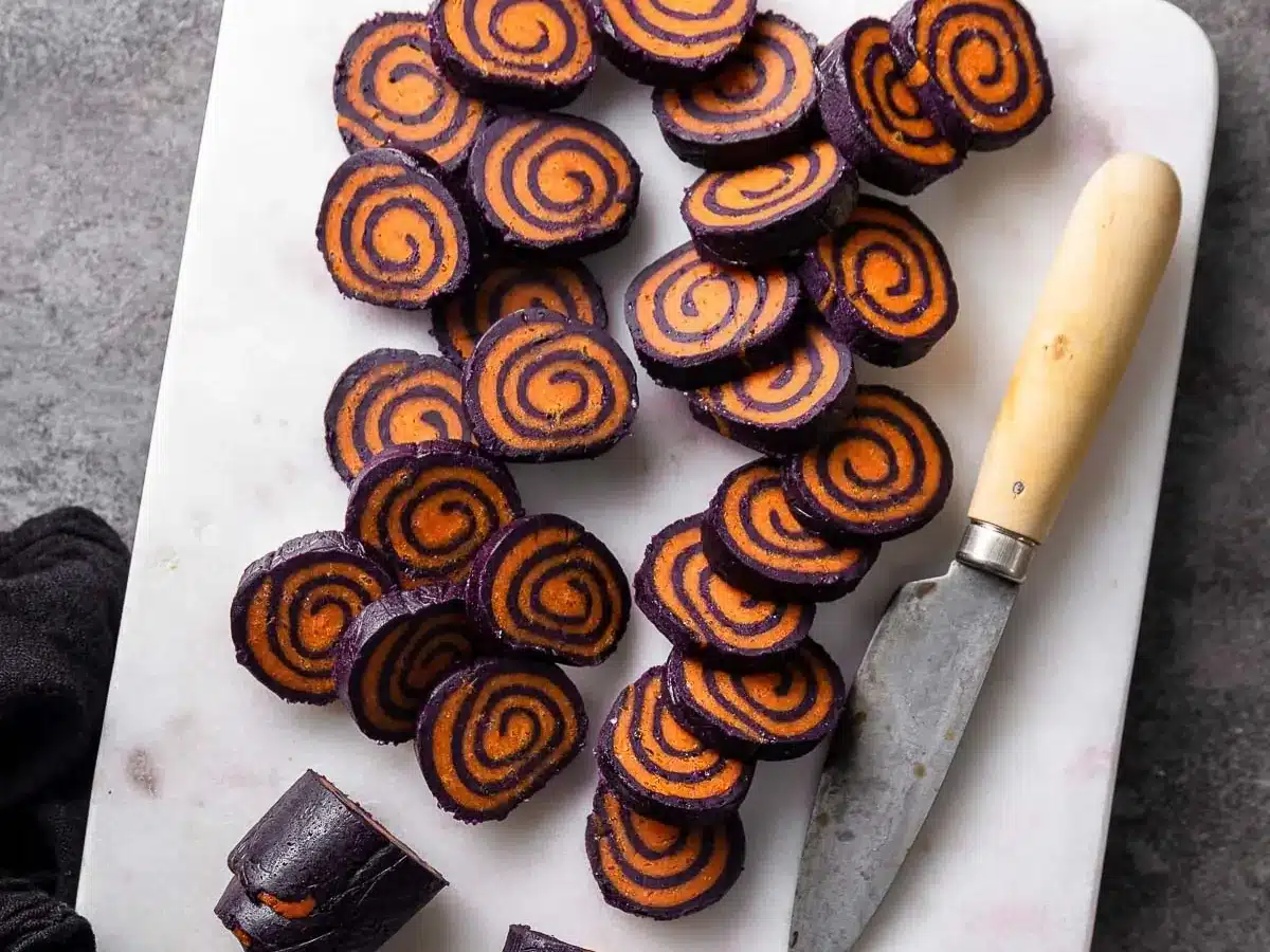 Purple and orange swirled dough slices.