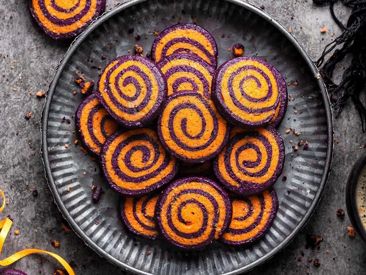Plate full of sugar cookies with colorful swirls.