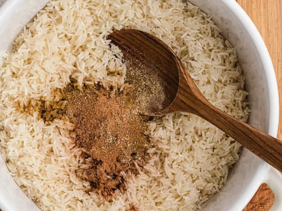 Dry spices being added to cooked rice.