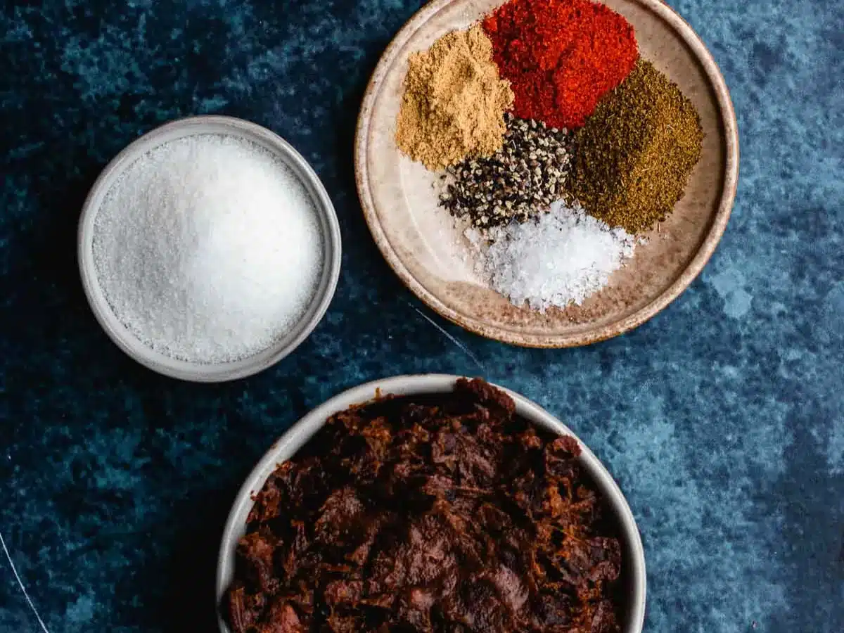 Dry spices, and tamarind paste in separate ramekins.