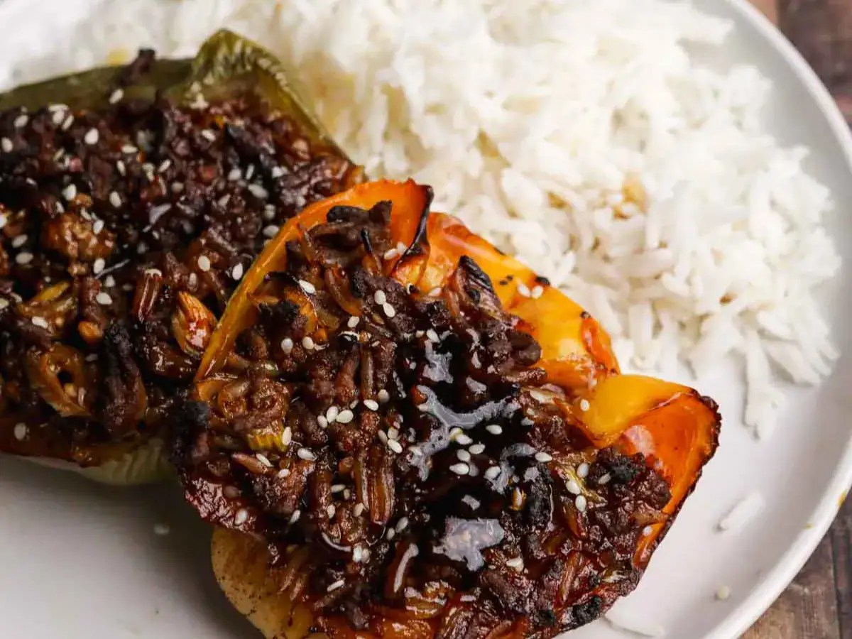 Beef and rice filled bell peppers with side of rice.