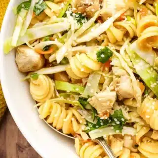 Pasta salad in bowl with chicken and veggies.