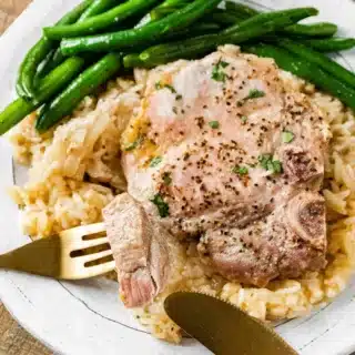 Dinner plate with pork, rice, and green beans.