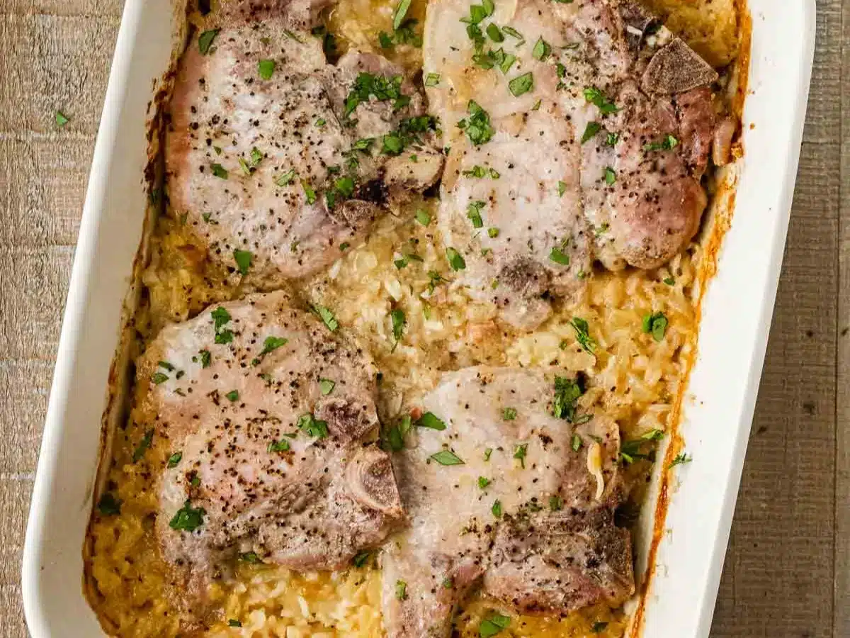 Baked pork with rice in baking dish.