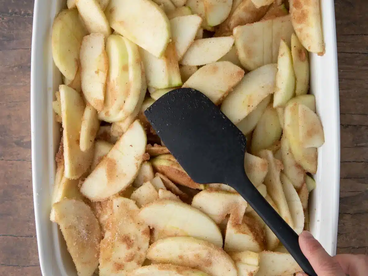 Sliced and spiced apples in deep baking dish.